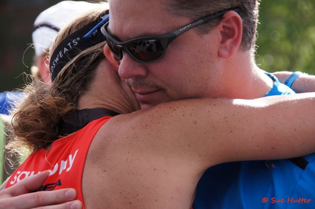 Meredith Kessler and husband Aaron Kessler hug finish line Ironman St. George