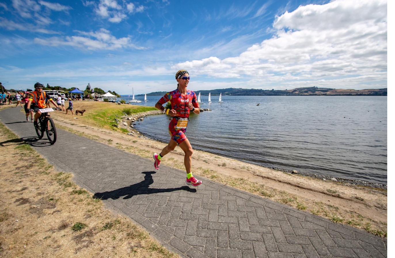 Meredith running along a lakefront path