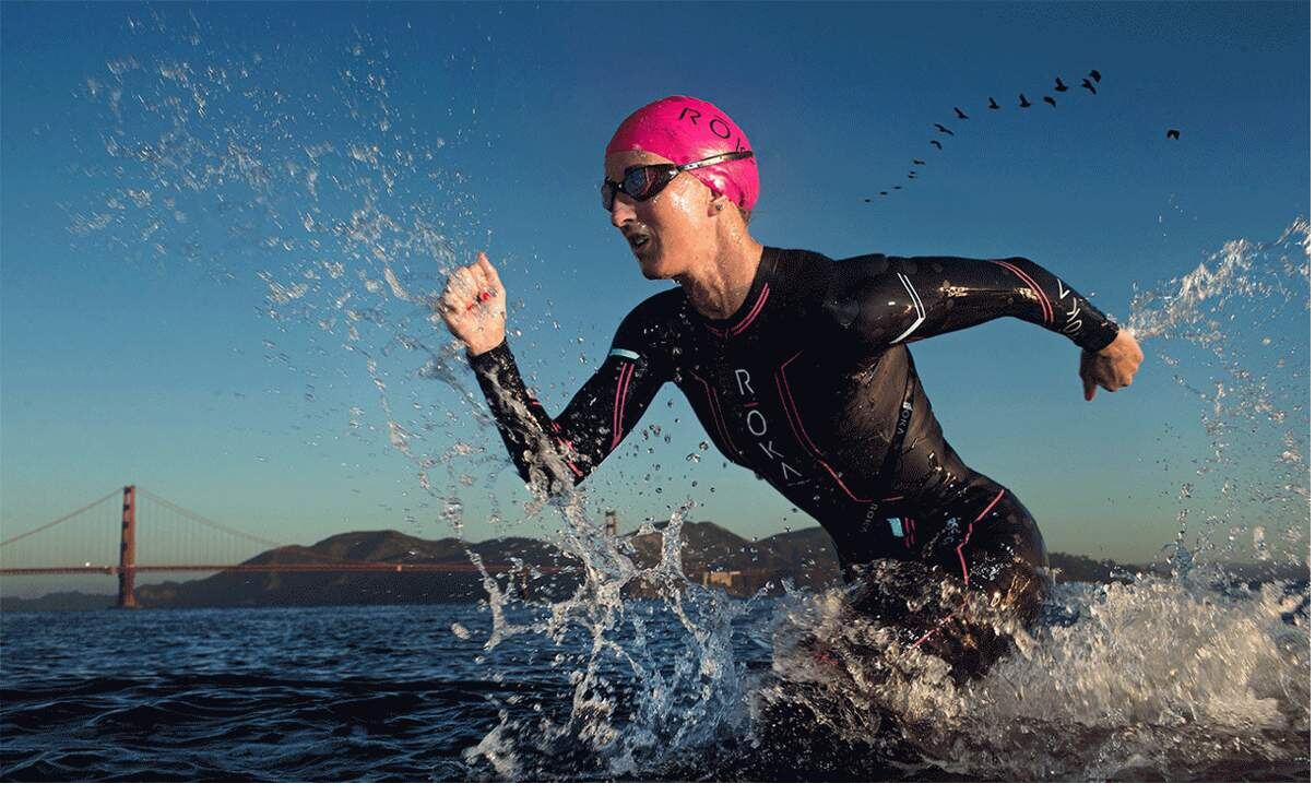Meredith Kessler charging out of San Francisco Bay, Golden Gate Bridge behind her