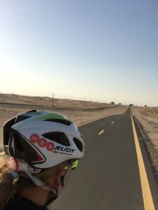 Meredith Kessler riding bike in Dubai on 180k track in desert