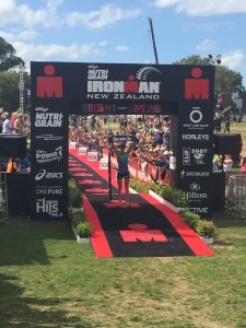 Meredith Kessler Ironman New Zealand raising banner over head